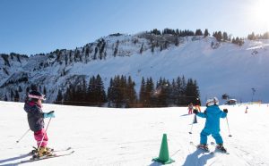 2 jeunes enfants sur une piste de ski